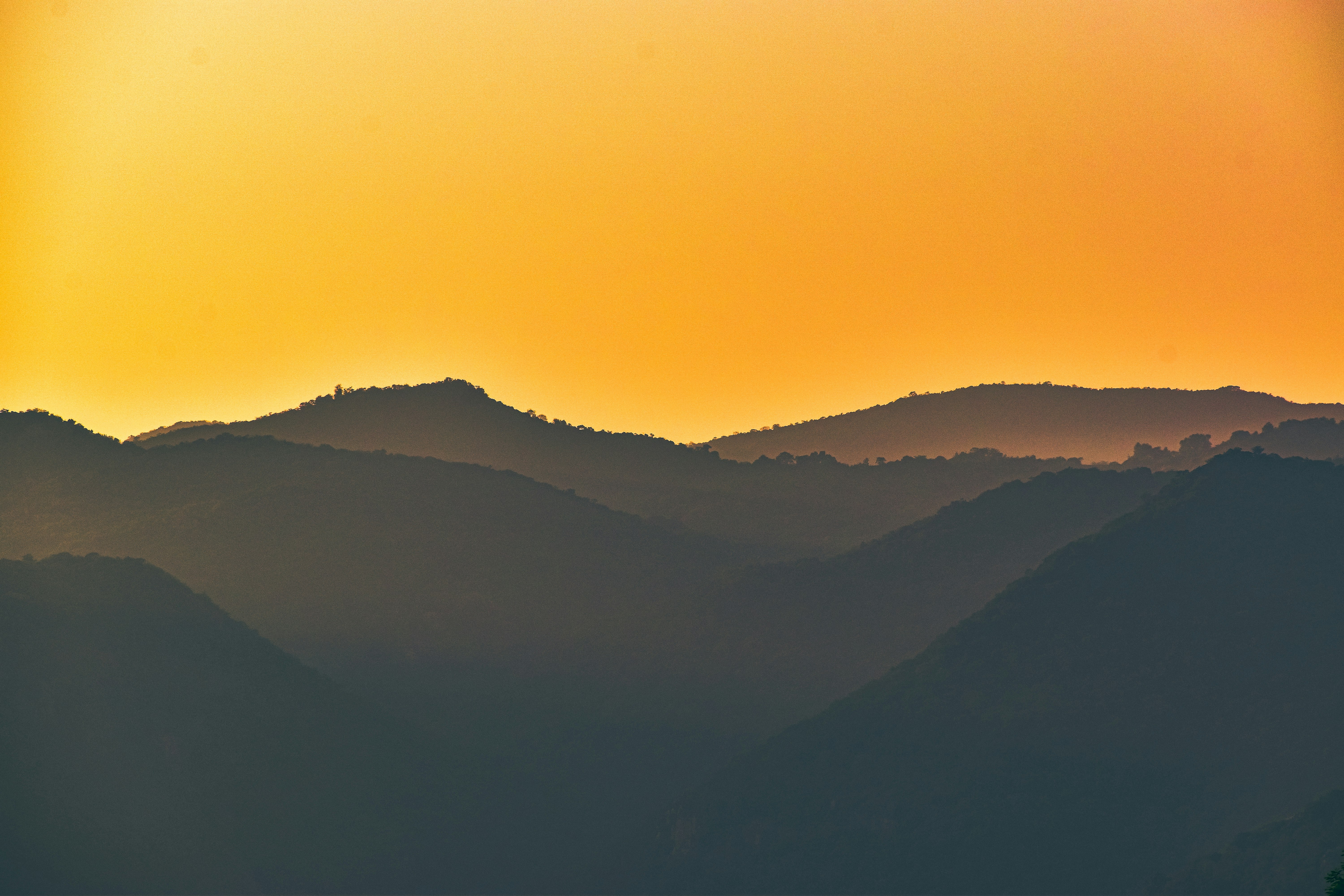 silhouette of mountains during sunset